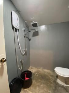 a bathroom with a toilet and a trash can at Dee Siargaonon Homestay in General Luna