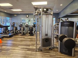 a gym with a row of tread machines in a room at Endearing Private Bedroom in Shared House in Reunion Resort in Kissimmee
