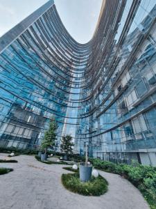 a large glass building with a courtyard in front of it at On Paseo de la Reforma, great location, luxurious, pool, gym, AC in Mexico City