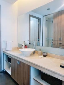 a bathroom counter with a sink and a mirror at On Paseo de la Reforma, great location, luxurious, pool, gym in Mexico City +35 photos