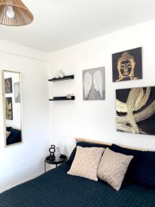 a bedroom with a bed and some pictures on the wall at Chic Retreat: 2-Bed 1 Ensuite Oasis in Birmingham