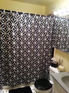 a bathroom with a black and white patterned wall at Centrally located; Walk anywhere! in San Francisco