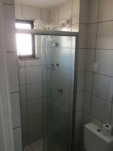 a bathroom with a glass shower with a toilet at Apartamento MOBILIADO 200m do mar com vista mar, garagem, ar condicionado in Fortaleza
