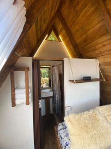 an attic room with a bed and a window at Glamping Monte Cristal in San Francisco +18 photos
