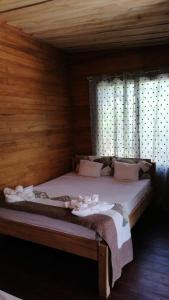 Cama en habitación con paredes y ventanas de madera en Terrazas del Golfo, en La Palma