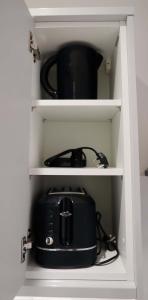 a toaster sitting in a cabinet with a tea pot at Modern City Escape by TTLG Stays in Rickmansworth