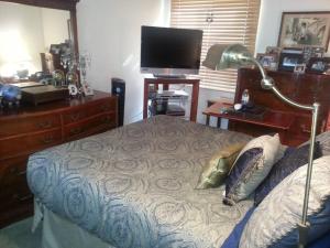 a bedroom with a bed with a desk and a television at Entire 2BR, centrally-located, w/parking! in San Francisco