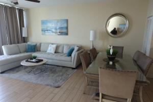 a living room with a couch and a table at AQUA 1504 Beachfront condo with Free Beach Chairs in Panama City Beach