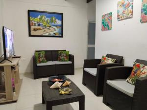a living room with couches and a tv at Mayo´s Place in San Andrés