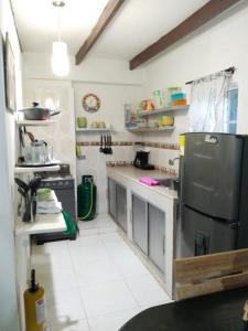 a kitchen with a stainless steel refrigerator and white tile floors at Mayo´s Place in San Andrés