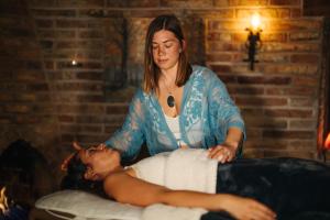 a woman is giving a man a massage at Private, Modern, Luxury Studio With Unmatched Red Rock Views Private Trail Head - Enjoy on property Sauna, Aromatherapy Steam Room, Hot Tub, Pools and Wellness Services in Sedona