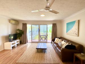 a living room with a couch and a tv at Surfers Tradewinds in Gold Coast