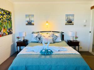 a woman in a dress laying on a bed at Wallaroo Sunset home in Wallaroo