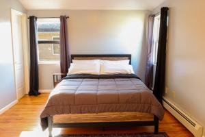 a bedroom with a bed with a large window at BGI Rentals in Brooklyn