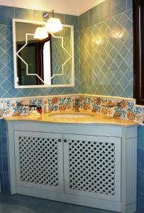 a bathroom with a sink and a mirror at iGV Club Santagiusta in Castiadas