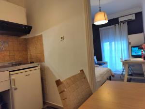 uma cozinha e sala de estar com uma mesa e um sofá em Diva - Free Parking - Explore Center by foot - Close to Helexpo, University & Hospital em Tessalônica