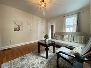 a living room with a couch and a table at Boston 2bd- Walk to Harvard, MIT, subway Parking in Somerville
