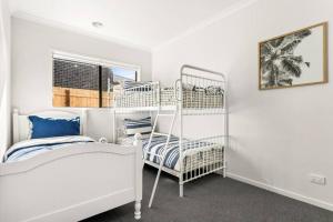 a bedroom with two bunk beds and a window at Elsa Remo - Stylish Ultra modern in San Remo