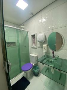 a bathroom with a glass shower and a toilet at Conexão 021 in Boa Vista