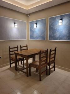 a dining room with a wooden table and chairs at Hotel Ananda Kashi in Varanasi