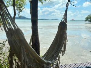 a hammock hanging from a tree on a beach at Deep House Sea View in Ko Lanta