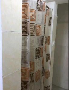 a shower curtain with a geometric pattern on a wall at Ajay's residence in Hanya