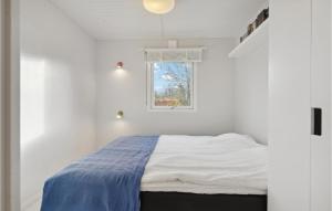 a white bedroom with a bed and a window at Lovely Home In Frvang With Kitchen in Fårvang