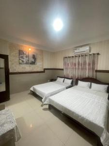 Ein Bett oder Betten in einem Zimmer der Unterkunft Khách sạn Tân Kim Chung