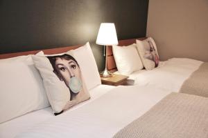 a hotel room with two beds with a picture of a man at ZONK HOTEL Nakasu in Fukuoka
