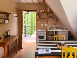 a small kitchen with a table and a stove at The Clarens Country House in Clarens