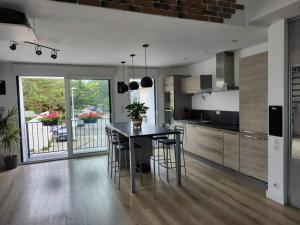 a kitchen with a table and chairs in a room at Maison Vue Mer in Pornichet +6 photos