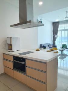 a kitchen with a sink and a stove top oven at Southbay Seaview Condo A11 #Queensbay #SPICE in Bayan Lepas