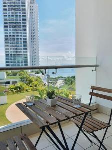 a wooden bench sitting on top of a balcony at Southbay Seaview Condo A11 #Queensbay #SPICE in Bayan Lepas