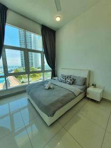 a bedroom with a bed and a large window at Southbay Seaview Condo A11 #Queensbay #SPICE in Bayan Lepas