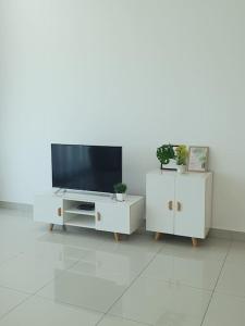 a living room with a tv and a white cabinet at Southbay Seaview Condo A11 #Queensbay #SPICE in Bayan Lepas