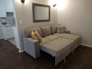 a couch in a living room with a mirror at Charming 1Bedroom Vacation Condo in Oceanside +27 photos