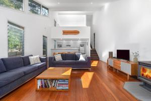 a living room with a couch and a coffee table at Boathouse 1 Hyams Beach in Hyams Beach