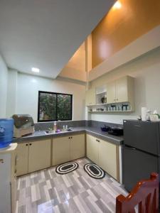 a large kitchen with a sink and a refrigerator at Private Comfortable Guest House in Alburquerque
