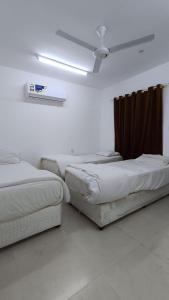 a room with three beds and a ceiling at Discovery Camp Bidiya in Badīyah