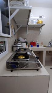a kitchen with a stove top in a kitchen at Discovery Camp Bidiya in Badīyah