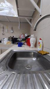 a kitchen counter with a sink in a kitchen at Discovery Camp Bidiya in Badīyah