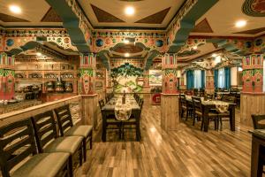 a restaurant with tables and chairs in a room at HOTEL CHANTSA in Leh