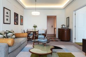 a living room with a couch and a table at The Westin Dubai Mina Seyahi Beach Resort and Waterpark in Dubai