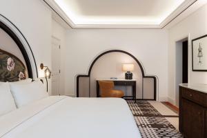 a hotel room with a bed and a desk at The Westin Dubai Mina Seyahi Beach Resort and Waterpark in Dubai