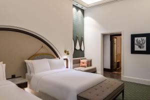 a bedroom with a large white bed and a chair at The Westin Dubai Mina Seyahi Beach Resort and Waterpark in Dubai