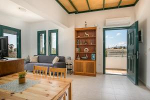 a living room with a couch and a table at Kelly's Beach House 1 in Gennadi
