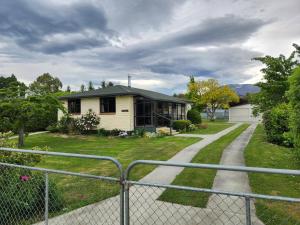 a house with a fence in front of it at Rockhampton in Kurow