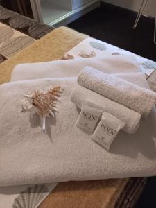 a pile of towels sitting on top of a bed at Ningaloo Lodge Exmouth in Exmouth