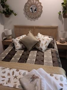 a bed with a comforter and pillows on it at Ningaloo Lodge Exmouth in Exmouth +37 photos