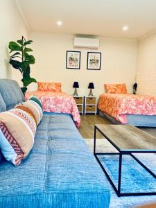 a living room with two beds and a couch at Yarra Gem in Yarra Glen